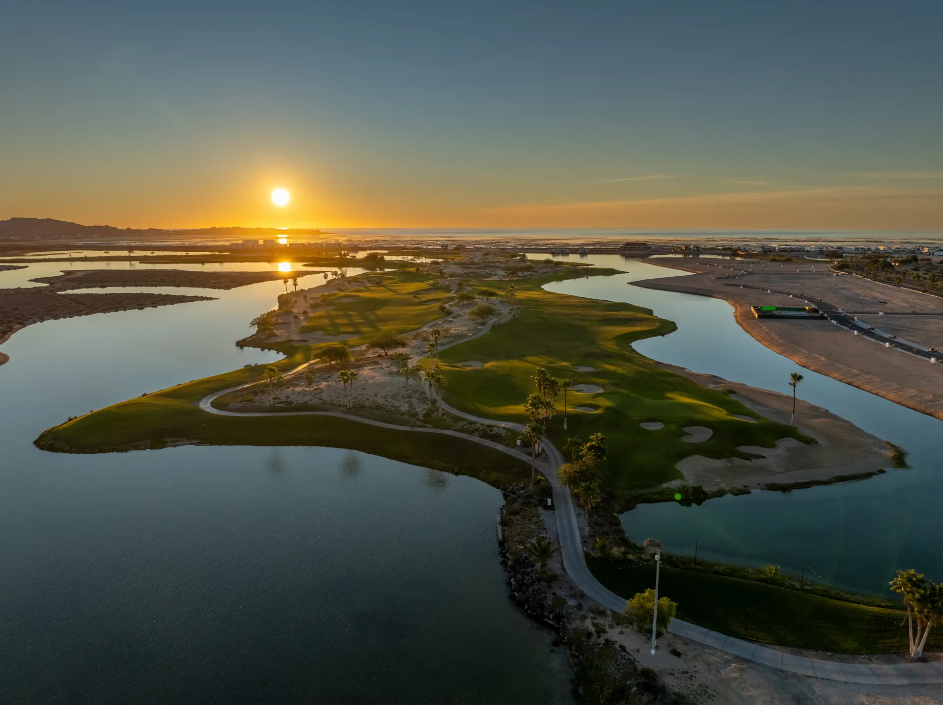 Sunset over the Jack Nicklaus Signature course and its lagoons